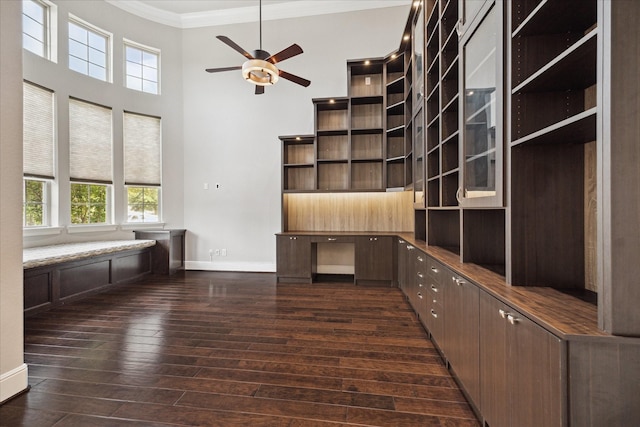10306 Grape Creek Grove Ln, Cypress, TX 77433 - unfurnished office featuring crown molding, ceiling fan, baseboards, dark wood finished floors, and a towering ceiling