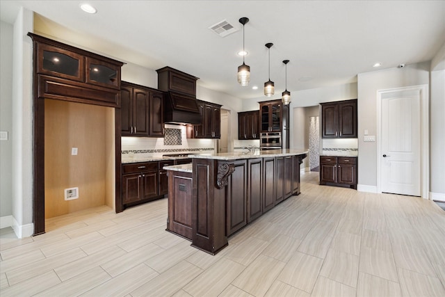 10306 Grape Creek Grove Ln, Cypress, TX 77433 - kitchen featuring appliances with stainless steel finishes, backsplash, glass insert cabinets, dark brown cabinetry, and recessed lighting