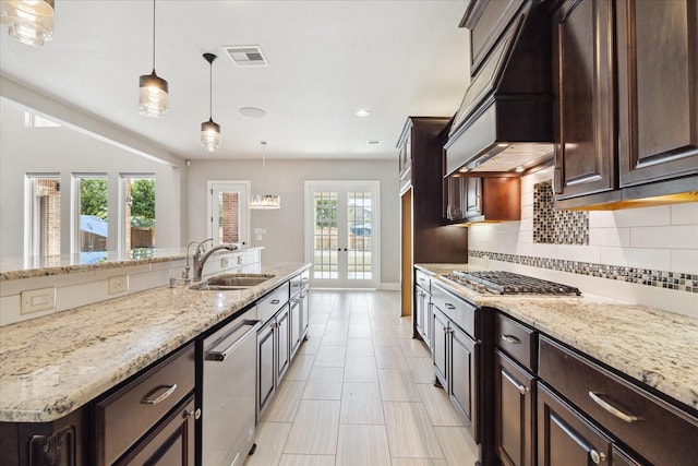 10306 Grape Creek Grove Ln, Cypress, TX 77433 - kitchen with a sink, stainless steel appliances, custom exhaust hood, tasteful backsplash, and dark brown cabinetry