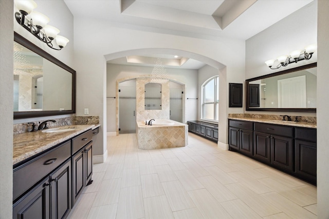10306 Grape Creek Grove Ln, Cypress, TX 77433 - full bath with a raised ceiling, two vanities, a bath, and baseboards