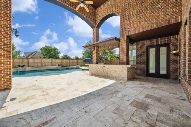 10306 Grape Creek Grove Ln, Cypress, TX 77433 - fenced backyard with french doors, ceiling fan, exterior kitchen, and a patio area