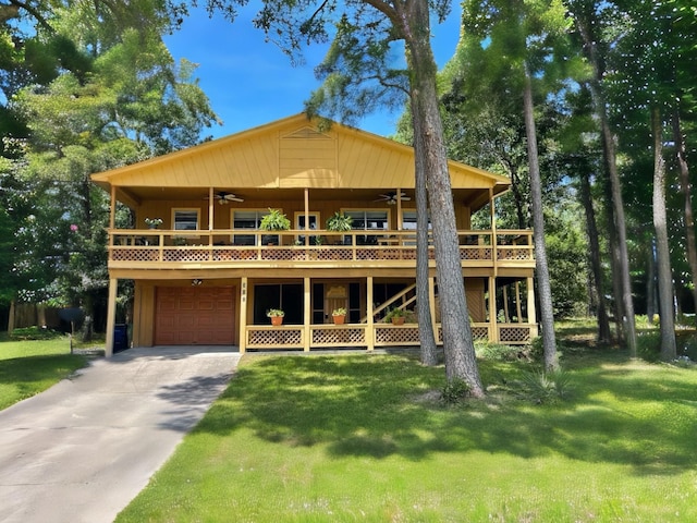 311 Harbor Dr, Onalaska, TX 77360 - view of front of property featuring ceiling fan, a front lawn, a garage, and a deck