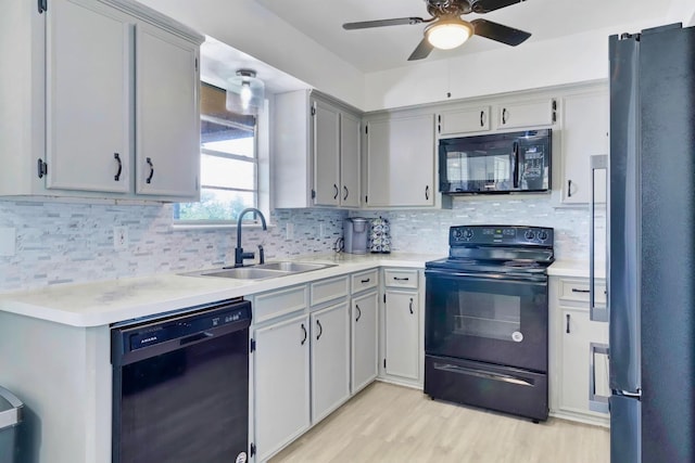 311 Harbor Dr, Onalaska, TX 77360 - kitchen featuring black appliances, a sink, a ceiling fan, light countertops, and backsplash