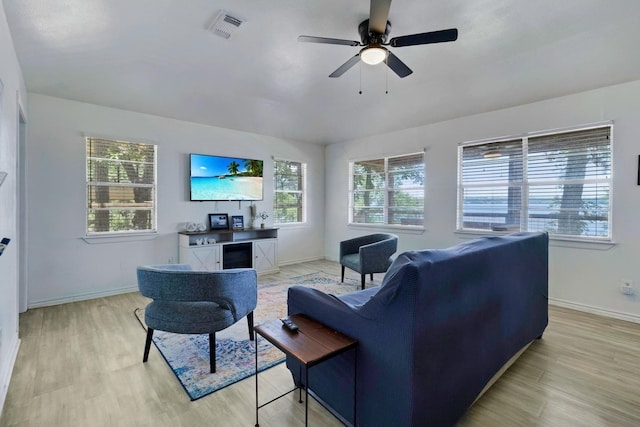311 Harbor Dr, Onalaska, TX 77360 - living room featuring healthy amount of natural light, baseboards, light wood finished floors, and ceiling fan
