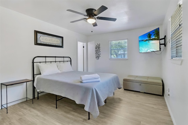311 Harbor Dr, Onalaska, TX 77360 - bedroom with wood finished floors, baseboards, and ceiling fan