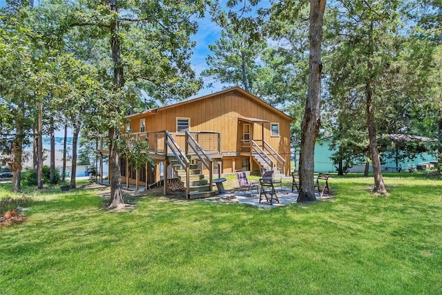 311 Harbor Dr, Onalaska, TX 77360 - rear view of house with stairway, a deck, a patio area, and a yard
