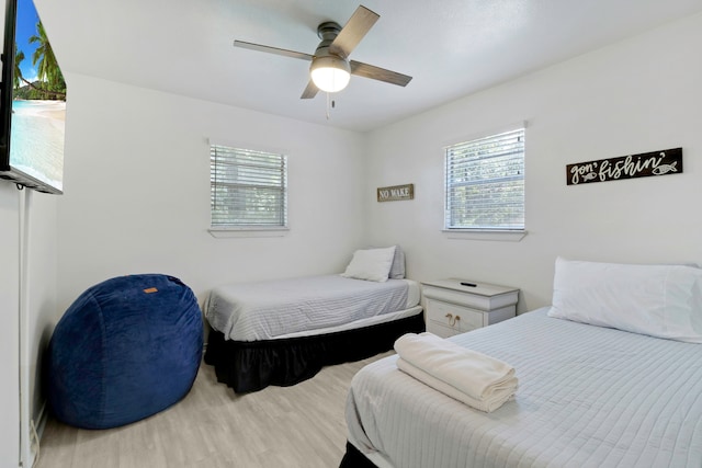 311 Harbor Dr, Onalaska, TX 77360 - bedroom with multiple windows, wood finished floors, and ceiling fan