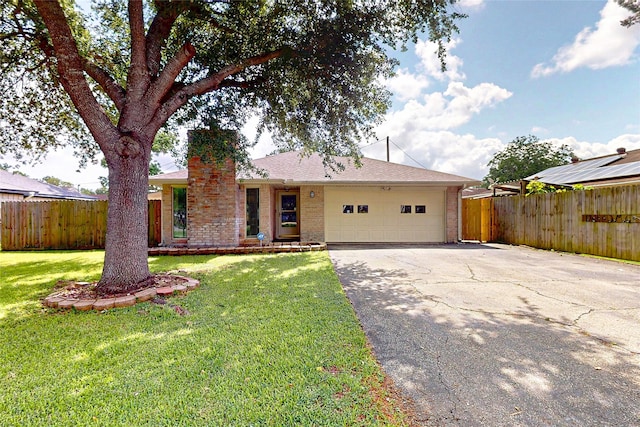 3907 Texas Ave, Dickinson, TX 77539 - ranch-style house featuring brick siding, an attached garage, asphalt driveway, and a chimney