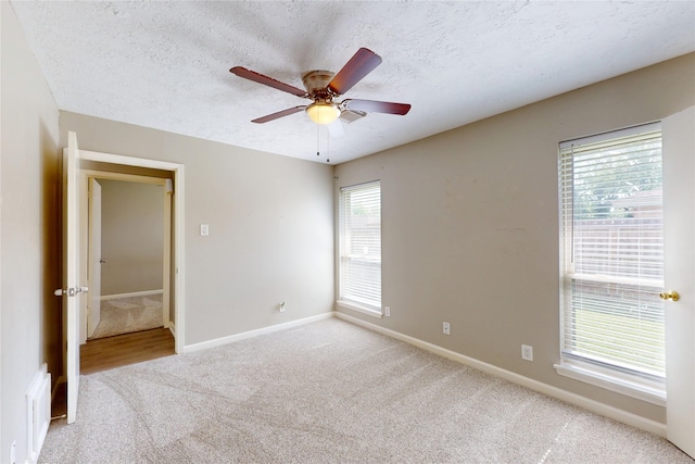 3907 Texas Ave, Dickinson, TX 77539 - carpeted empty room featuring baseboards, a textured ceiling, and a ceiling fan
