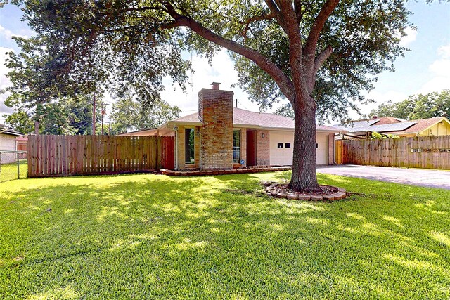 3907 Texas Ave, Dickinson, TX 77539 - single story home featuring asphalt driveway, a chimney, a garage, and brick siding
