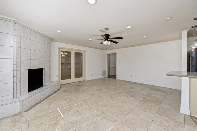 8007 Twin Hills Dr, Houston, TX 77071 - unfurnished living room featuring crown molding, a tile fireplace, recessed lighting, ceiling fan, and french doors