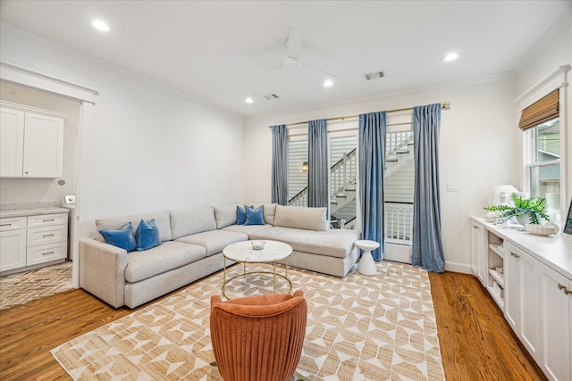 1336 Tulane St, Houston, TX 77008 - living area with light wood-style floors, ornamental molding, a ceiling fan, recessed lighting, and stairway