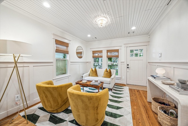 1336 Tulane St, Houston, TX 77008 - living area with ornamental molding, a decorative wall, wainscoting, wooden ceiling, and light wood finished floors