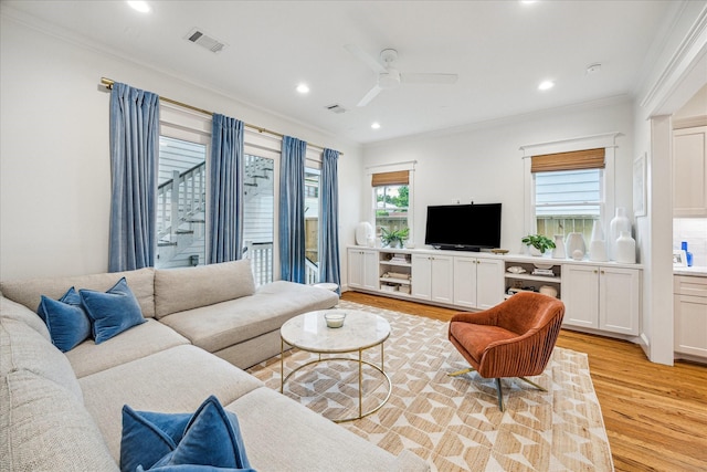 1336 Tulane St, Houston, TX 77008 - living room featuring light wood-type flooring, crown molding, a ceiling fan, recessed lighting, and stairs