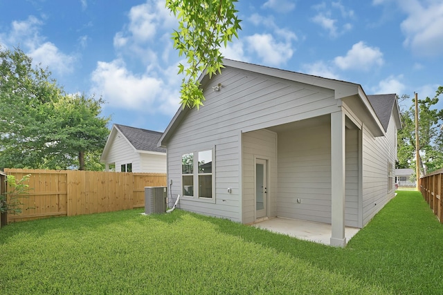 90 Burres St Unit B, Houston, TX 77022 - back of house with central AC unit, roof with shingles, and a patio