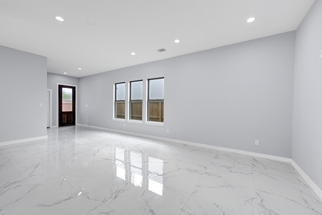 90 Burres St Unit B, Houston, TX 77022 - unfurnished room featuring light marble finish flooring, recessed lighting, and baseboards