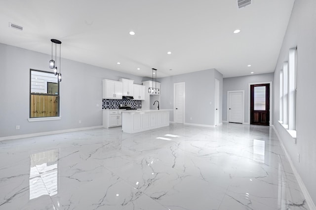 90 Burres St Unit B, Houston, TX 77022 - unfurnished living room with light marble finish flooring, baseboards, recessed lighting, and a sink