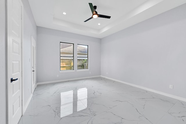 90 Burres St Unit B, Houston, TX 77022 - unfurnished bedroom featuring baseboards, recessed lighting, light marble finish flooring, a raised ceiling, and ceiling fan