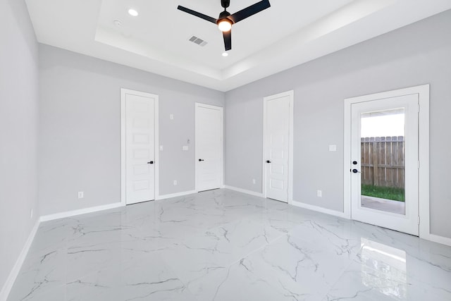 90 Burres St Unit B, Houston, TX 77022 - unfurnished bedroom featuring baseboards, recessed lighting, a tray ceiling, marble finish flooring, and a ceiling fan