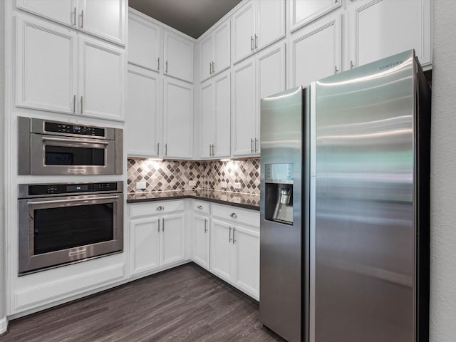 3466 Oakheath Manor Way, Houston, TX 77365 - kitchen featuring stainless steel appliances, dark countertops, dark wood-type flooring, and white cabinets