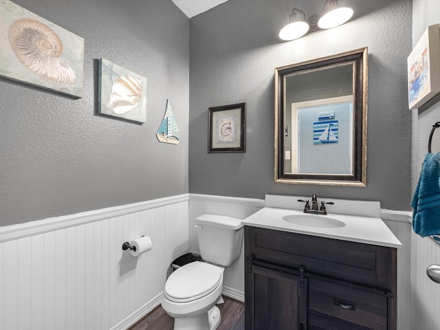 3466 Oakheath Manor Way, Houston, TX 77365 - bathroom featuring a wainscoted wall, toilet, vanity, and wood finished floors