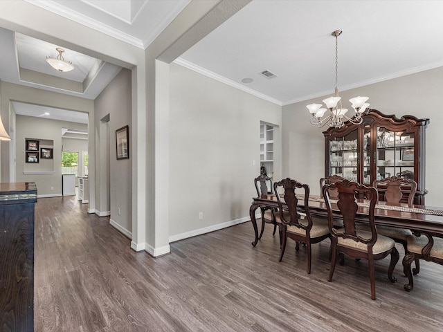 3466 Oakheath Manor Way, Houston, TX 77365 - dining room with dark wood-style flooring, baseboards, a chandelier, and crown molding