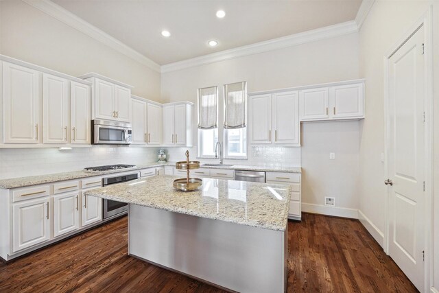 2713 Cohn Gdn, Houston, TX 77007 - kitchen featuring appliances with stainless steel finishes, crown molding, white cabinetry, backsplash, and recessed lighting