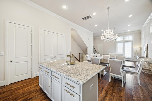 2713 Cohn Gdn, Houston, TX 77007 - kitchen with crown molding, dark wood-style floors, a kitchen island, recessed lighting, and a chandelier