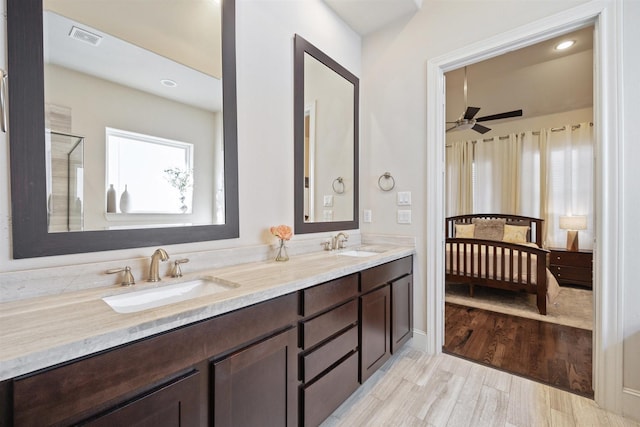 2713 Cohn Gdn, Houston, TX 77007 - bathroom with double vanity, ceiling fan, wood finished floors, an enclosed shower, and recessed lighting