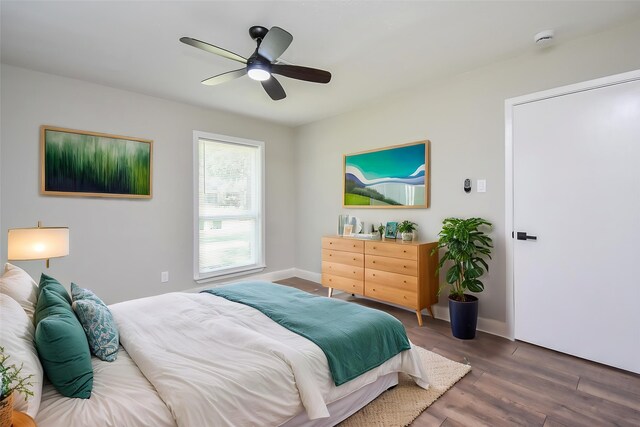 5906 Melanite Ave, Houston, TX 77053 - bedroom with wood finished floors, ceiling fan, and baseboards