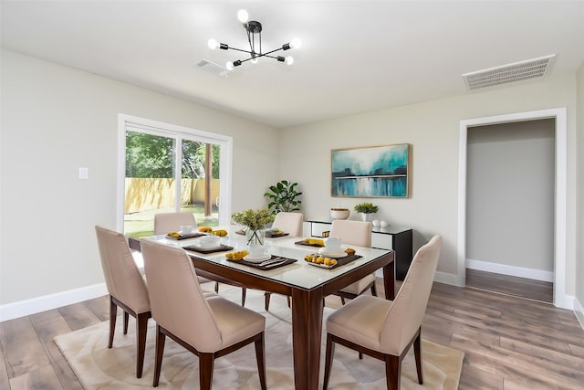 5906 Melanite Ave, Houston, TX 77053 - dining area with a chandelier, wood finished floors, and baseboards