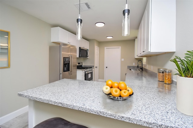 5906 Melanite Ave, Houston, TX 77053 - kitchen with appliances with stainless steel finishes, a sink, white cabinets, light stone counters, and baseboards