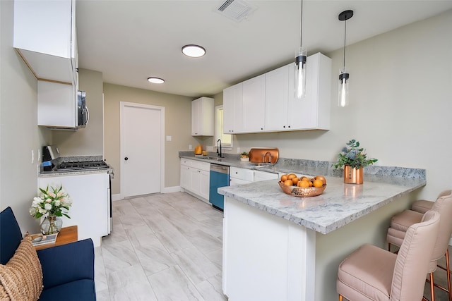 5906 Melanite Ave, Houston, TX 77053 - kitchen featuring dishwasher, range with gas stovetop, a peninsula, a sink, and a kitchen bar
