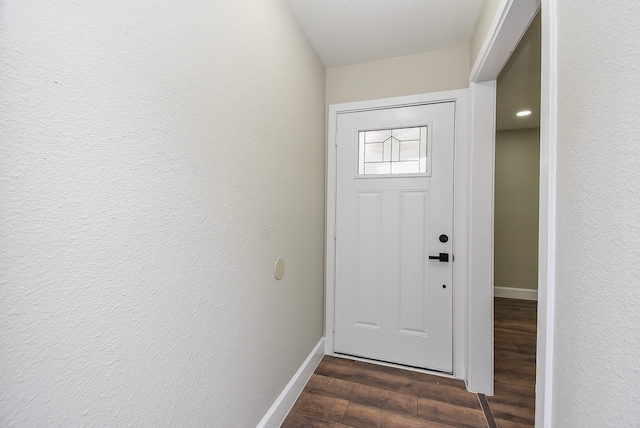 5906 Melanite Ave, Houston, TX 77053 - doorway to outside with baseboards and dark wood-style floors