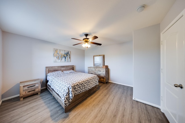 8106 Sweetstone Bluff Ln, Cypress, TX 77433 - bedroom with wood finished floors, baseboards, and ceiling fan
