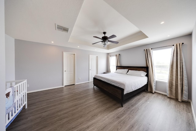 8106 Sweetstone Bluff Ln, Cypress, TX 77433 - bedroom featuring a raised ceiling, wood finished floors, baseboards, and recessed lighting