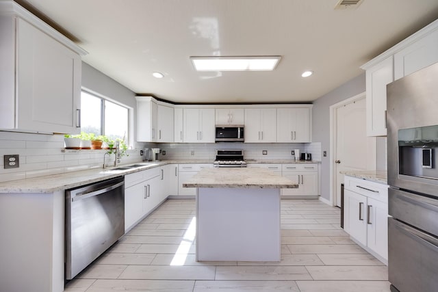 8106 Sweetstone Bluff Ln, Cypress, TX 77433 - kitchen featuring appliances with stainless steel finishes, a sink, tasteful backsplash, white cabinetry, and recessed lighting