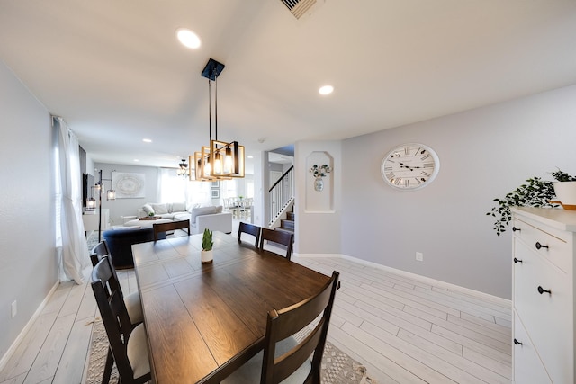 8106 Sweetstone Bluff Ln, Cypress, TX 77433 - dining area featuring light wood-style flooring, stairway, baseboards, a chandelier, and recessed lighting