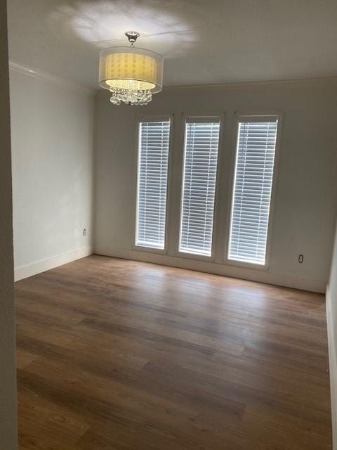 8107 S Braeswood Blvd, Houston, TX 77071 - spare room with a chandelier, ornamental molding, wood finished floors, and baseboards