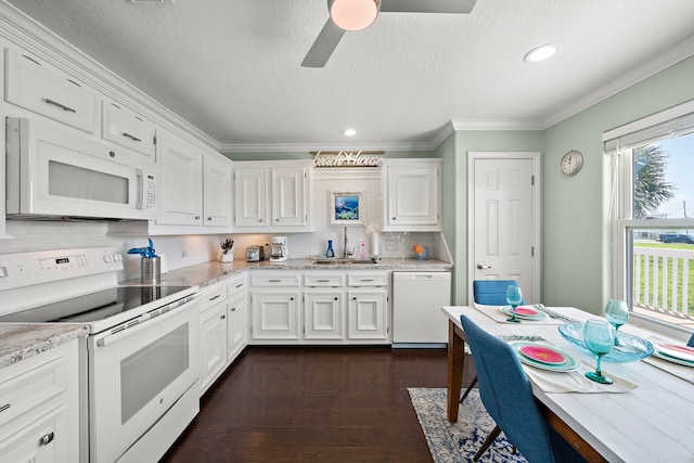 22321 Vista Del Mar, Galveston, TX 77554 - kitchen with white appliances, white cabinets, crown molding, dark wood-type flooring, and a sink