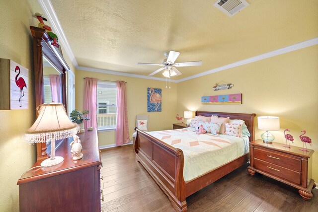 22321 Vista Del Mar, Galveston, TX 77554 - bedroom with ornamental molding, wood-type flooring, a textured ceiling, ceiling fan, and baseboards