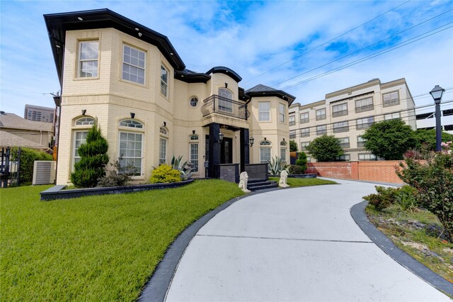 5302 Val Verde St, Houston, TX 77056 - view of front facade featuring a balcony, a front lawn, and central air condition unit
