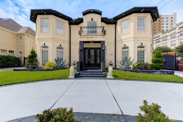 5302 Val Verde St, Houston, TX 77056 - view of front of property featuring a balcony, brick siding, a front yard, and french doors