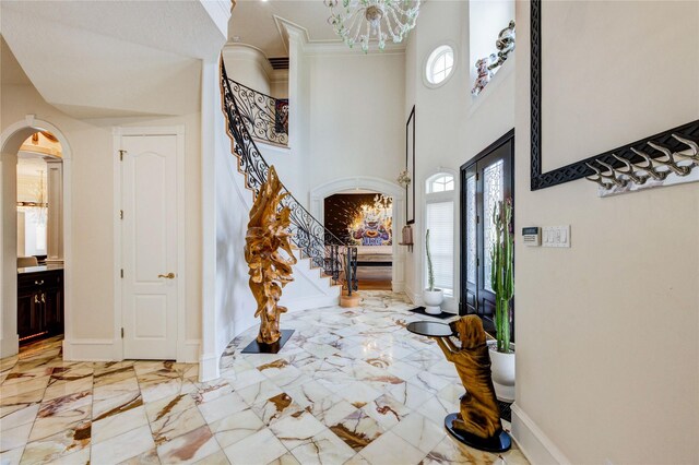5302 Val Verde St, Houston, TX 77056 - foyer with light marble finish flooring, arched walkways, stairs, a towering ceiling, and a chandelier