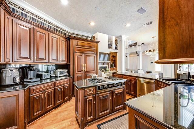 5302 Val Verde St, Houston, TX 77056 - kitchen featuring stainless steel appliances, crown molding, a sink, light wood finished floors, and a textured ceiling