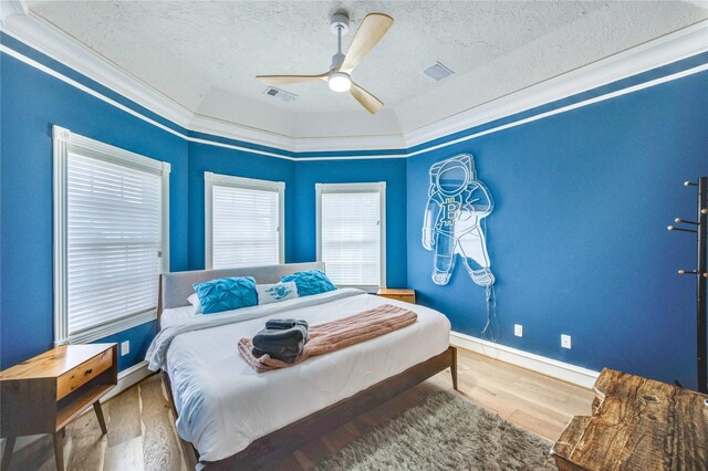 5302 Val Verde St, Houston, TX 77056 - bedroom with a textured ceiling, wood finished floors, baseboards, ornamental molding, and ceiling fan