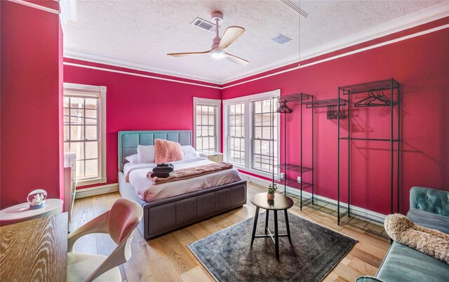 5302 Val Verde St, Houston, TX 77056 - bedroom with a textured ceiling, multiple windows, baseboards, crown molding, and wood finished floors