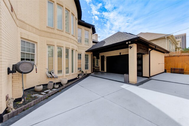 5302 Val Verde St, Houston, TX 77056 - view of property exterior with brick siding, a garage, driveway, and a shingled roof