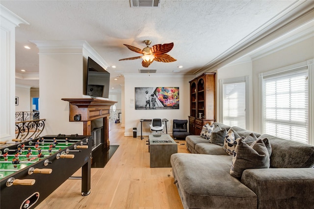5302 Val Verde St, Houston, TX 77056 - living area featuring crown molding, a ceiling fan, a fireplace with flush hearth, light wood-style floors, and recessed lighting
