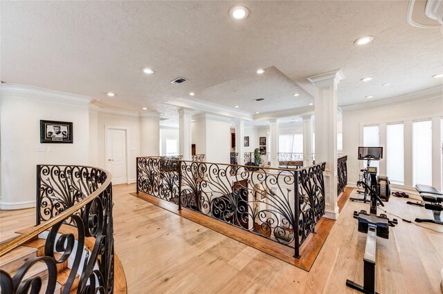 5302 Val Verde St, Houston, TX 77056 - hall with decorative columns, crown molding, light wood-style floors, an upstairs landing, and baseboards